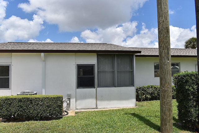 view of side of home with a yard