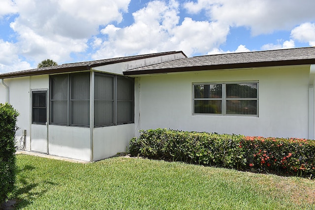 view of property exterior featuring a lawn