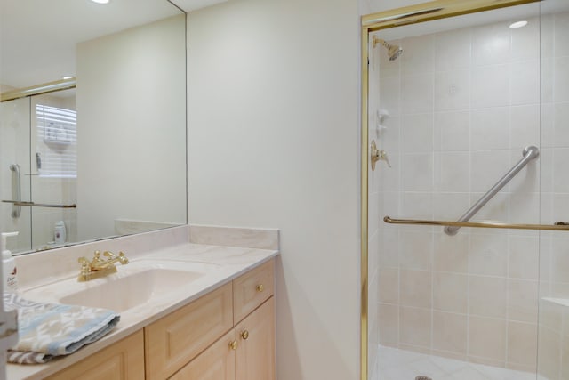 bathroom featuring walk in shower and vanity