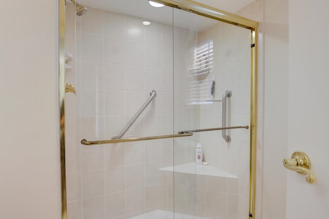 bathroom with a shower with door