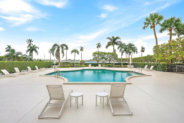 pool featuring fence and a patio