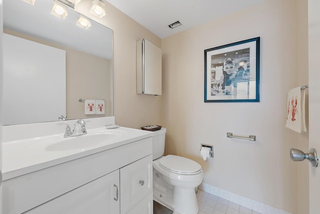 half bathroom with toilet, vanity, visible vents, baseboards, and tile patterned floors