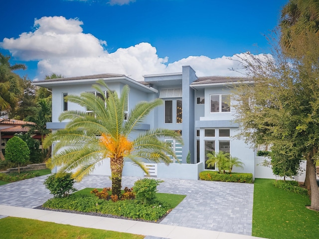 contemporary home featuring a front lawn