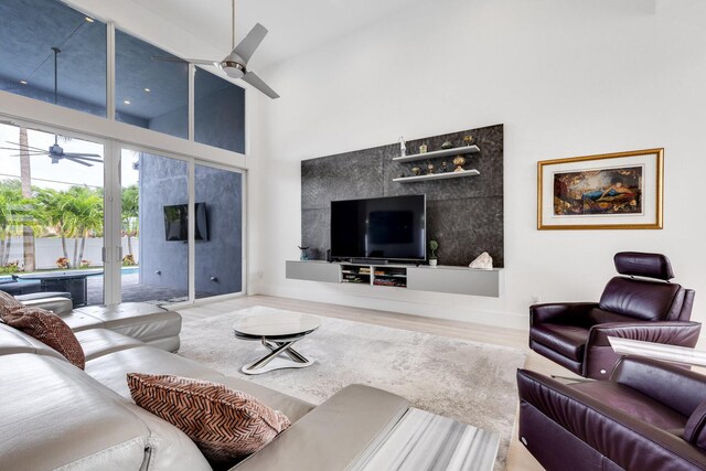 kitchen with pendant lighting, white cabinets, wall chimney exhaust hood, and stainless steel appliances