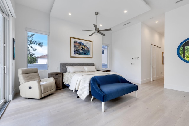 bedroom with light hardwood / wood-style floors and ceiling fan