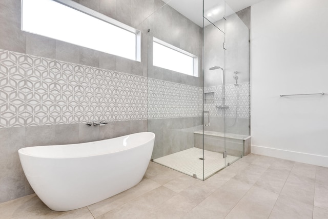 bathroom featuring tile walls, tile patterned flooring, and separate shower and tub