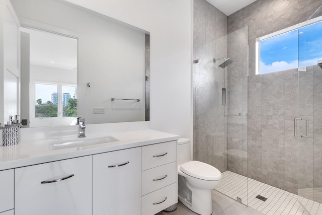 bathroom with toilet, vanity, tile patterned floors, and a shower with door