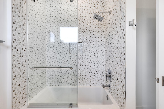 bathroom featuring combined bath / shower with glass door