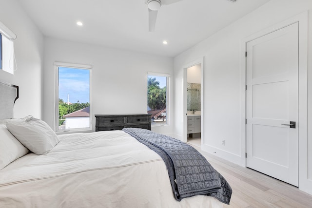 bedroom featuring ensuite bathroom, ceiling fan, and light hardwood / wood-style flooring