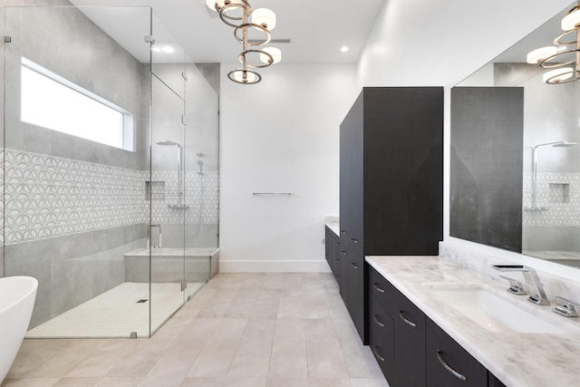 bathroom with independent shower and bath, tile patterned flooring, vanity, and tile walls