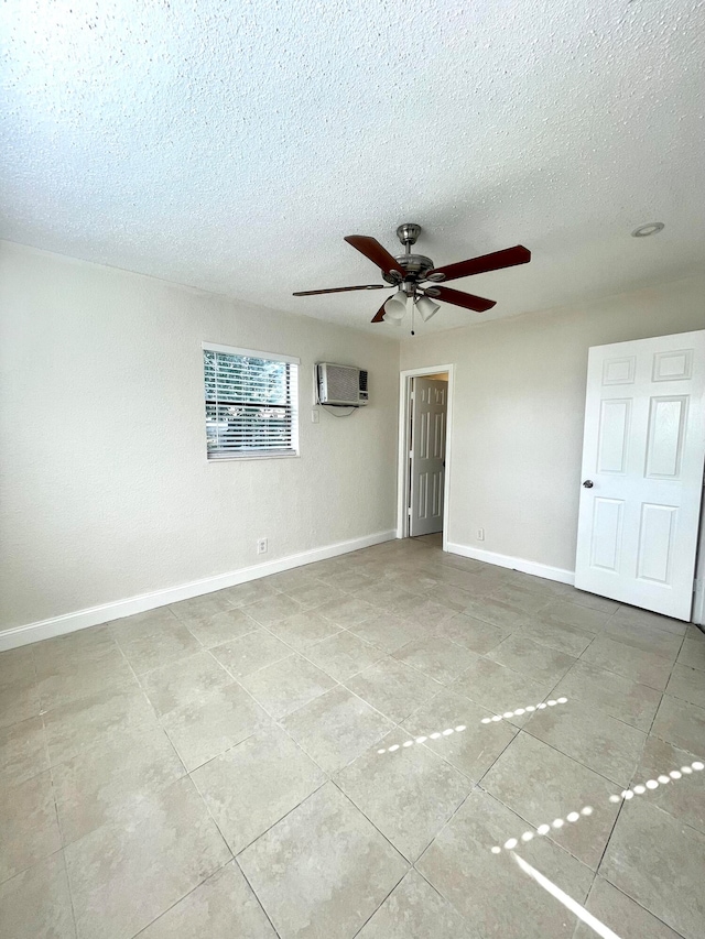 unfurnished room featuring ceiling fan, a textured ceiling, and a wall unit AC