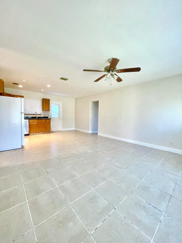 unfurnished living room featuring ceiling fan