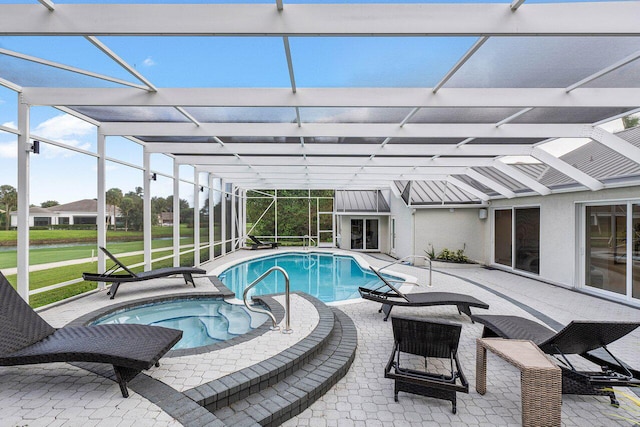 view of pool featuring a patio area, a lawn, a jacuzzi, and a lanai