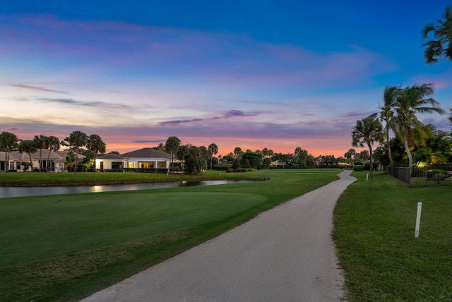 surrounding community with a lawn and a water view