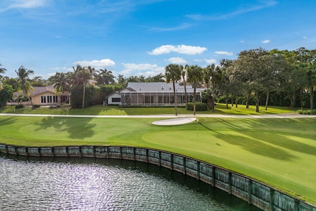 view of community featuring a lawn and a water view