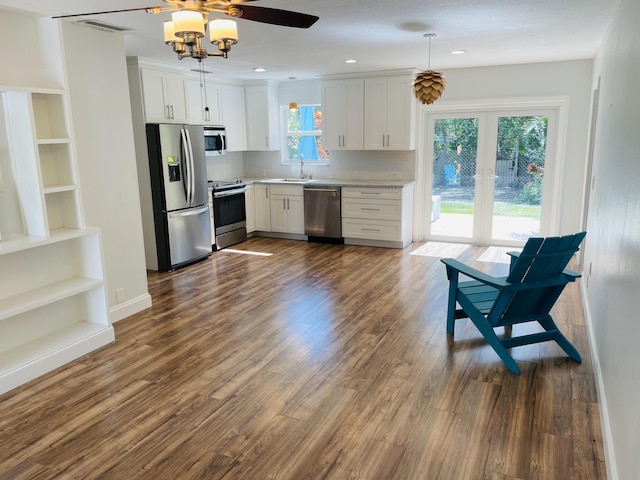 kitchen featuring stainless steel appliances, dark hardwood / wood-style floors, plenty of natural light, and white cabinetry