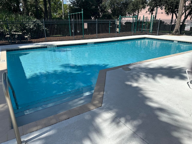 pool at dusk with a patio