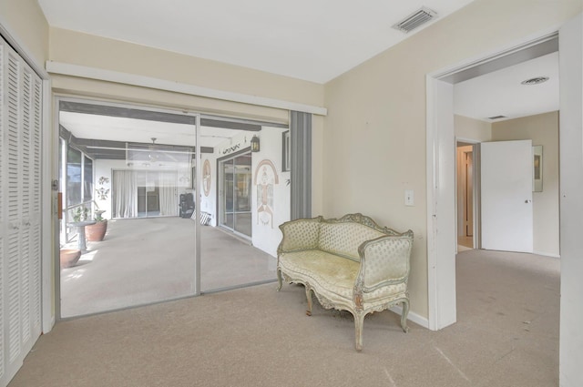 living area with light carpet