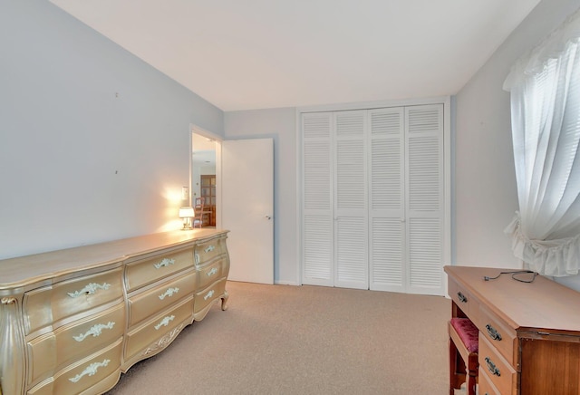 bedroom with light carpet and a closet