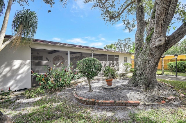 back of property with a sunroom