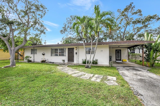 ranch-style home with a front yard and a carport