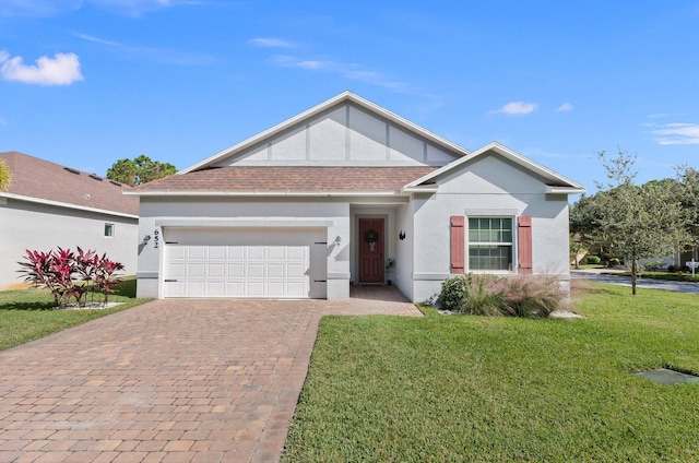 view of front of house with an attached garage, a shingled roof, decorative driveway, stucco siding, and a front lawn