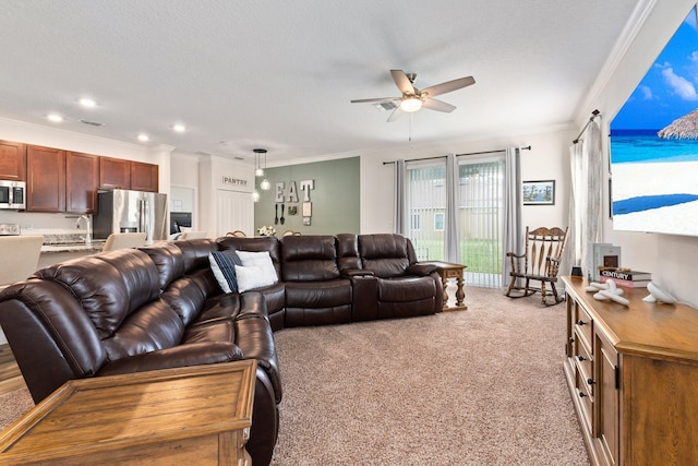 carpeted living room with a textured ceiling, ceiling fan, and crown molding