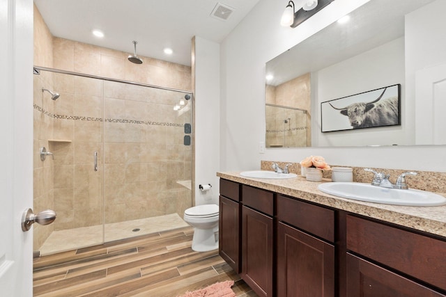 bathroom with vanity, an enclosed shower, and toilet