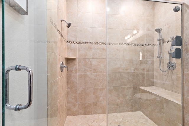 bathroom featuring a shower with shower door