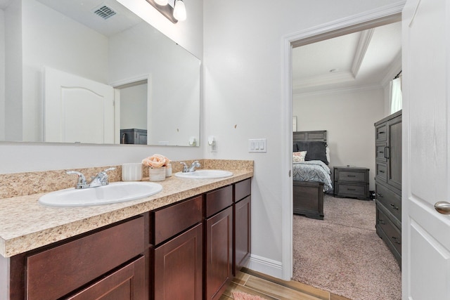 bathroom with hardwood / wood-style floors, vanity, and ornamental molding