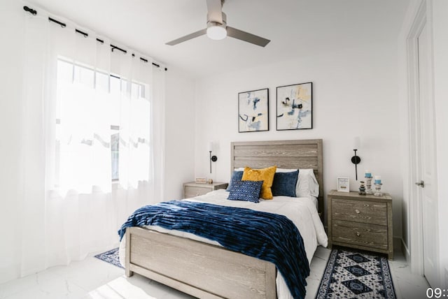 bedroom with multiple windows and ceiling fan