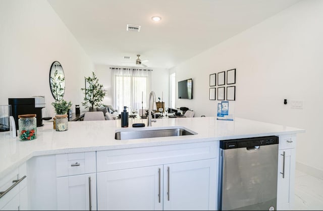 kitchen with white cabinetry, stainless steel dishwasher, sink, and ceiling fan