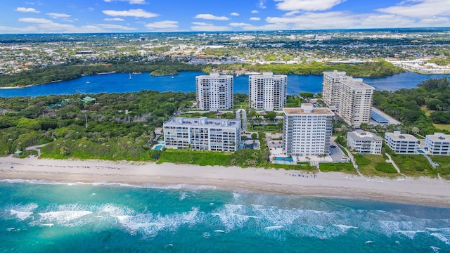 aerial view with a water view and a beach view