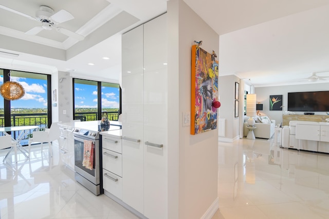 kitchen featuring stainless steel electric range oven, ceiling fan, light tile patterned floors, crown molding, and white cabinets