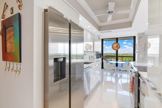 kitchen featuring white cabinets, ceiling fan, decorative light fixtures, light tile patterned flooring, and stainless steel appliances