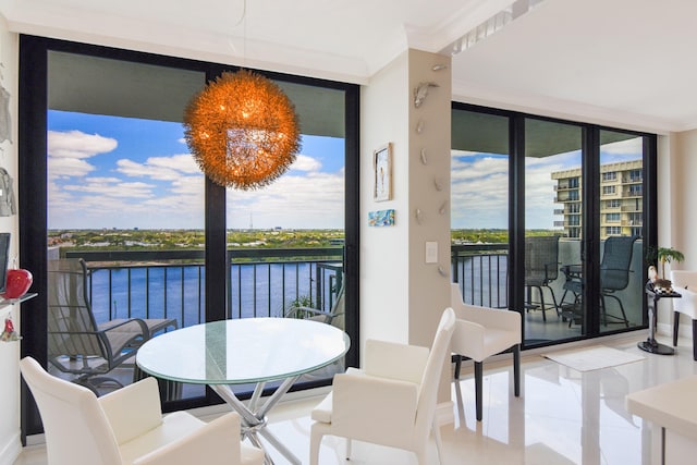 tiled dining room with expansive windows, a water view, and ornamental molding