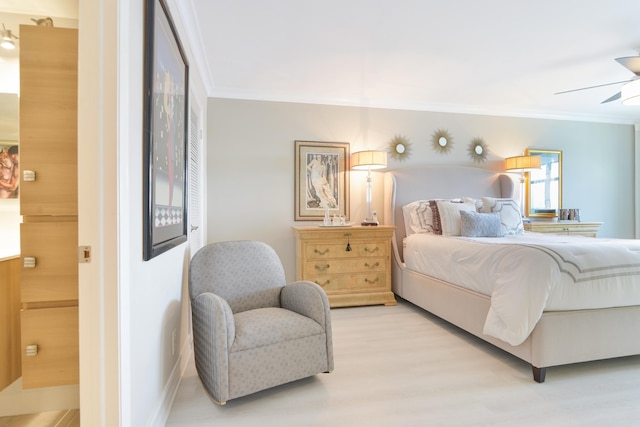 bedroom with ceiling fan, crown molding, and light wood-type flooring