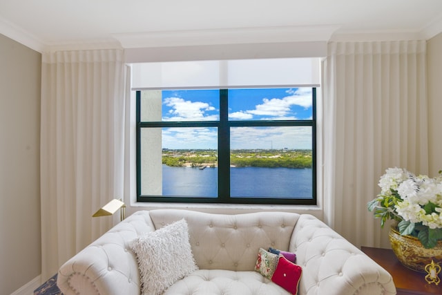 sitting room with a water view and ornamental molding