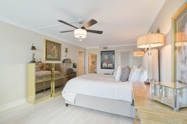 bedroom featuring ceiling fan, crown molding, and hardwood / wood-style flooring