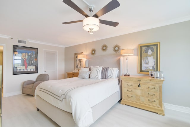 bedroom with ceiling fan, ornamental molding, and light hardwood / wood-style flooring