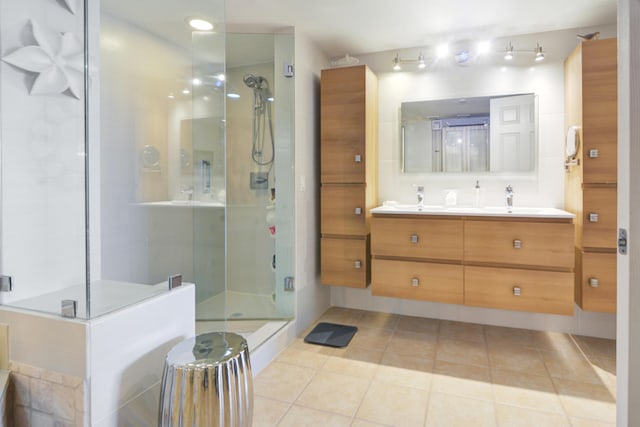 bathroom with tile patterned flooring, vanity, and a shower with shower door