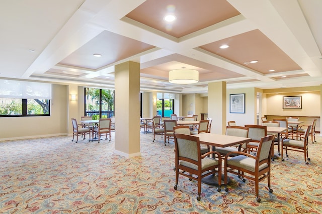 carpeted dining area with beam ceiling, plenty of natural light, and coffered ceiling