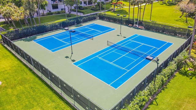 view of sport court featuring a lawn