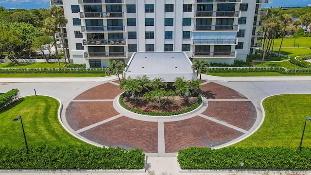 view of property's community with a lawn