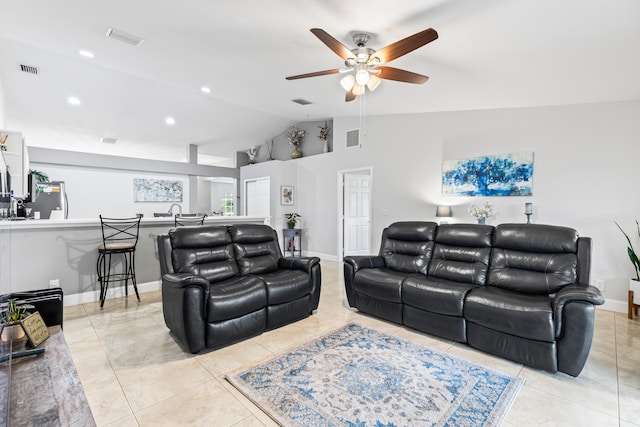 living room with ceiling fan, light tile patterned floors, and lofted ceiling