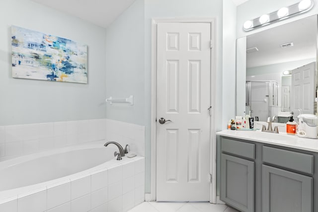 bathroom with tile patterned flooring, vanity, and separate shower and tub