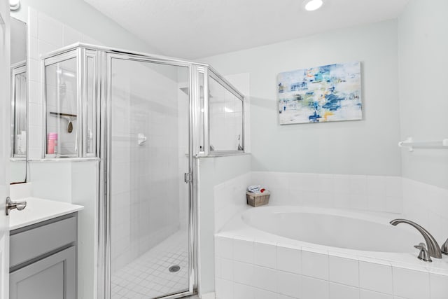 bathroom featuring vanity and plus walk in shower