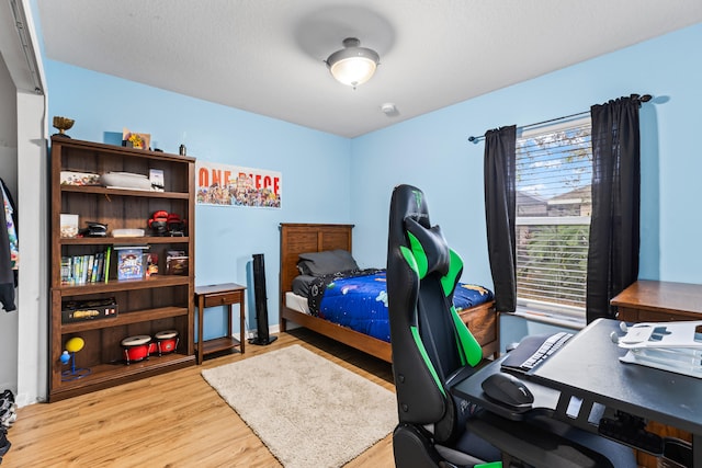 bedroom with light wood-type flooring