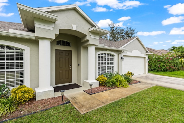 doorway to property featuring a garage and a yard