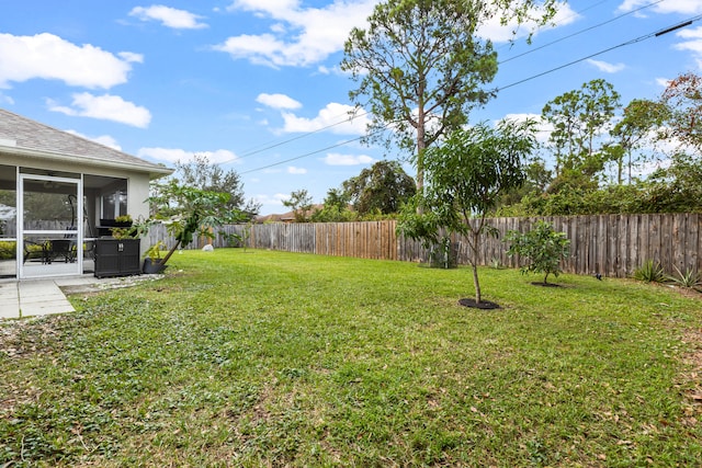 view of yard featuring a patio area and a sunroom